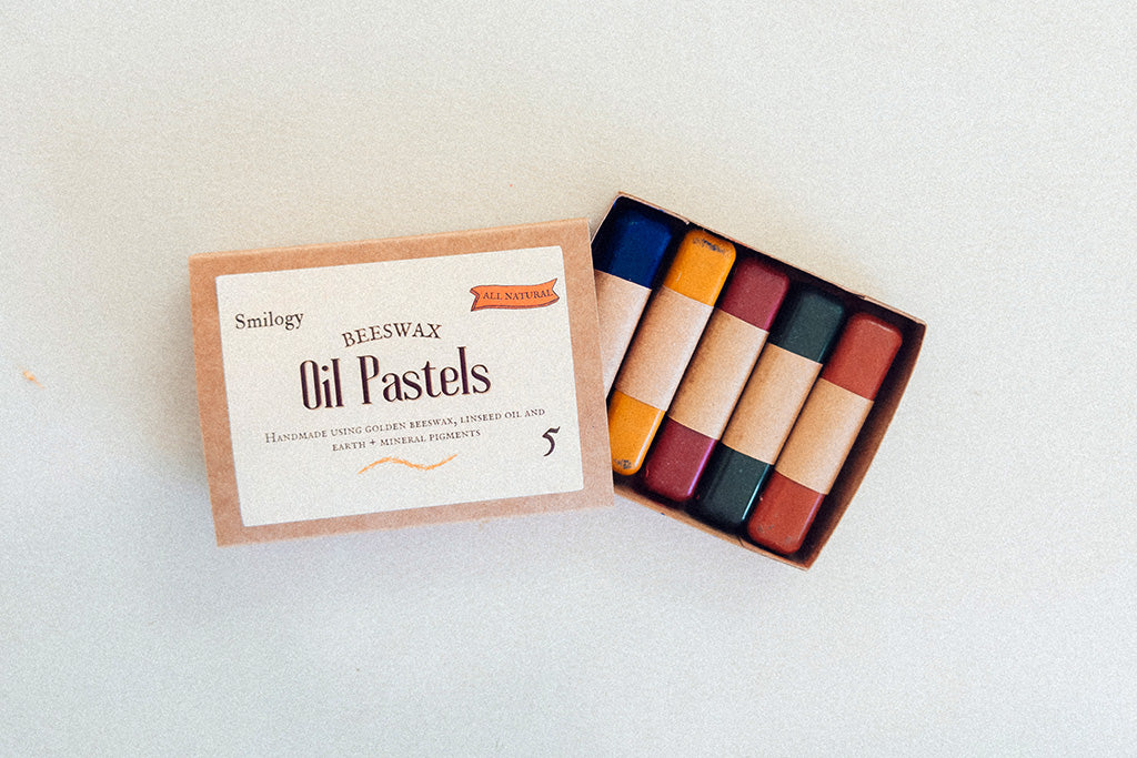 Set of five eco-friendly, non-toxic beeswax oil pastels in bright vivid colors, neatly packed in a recyclable kraft box