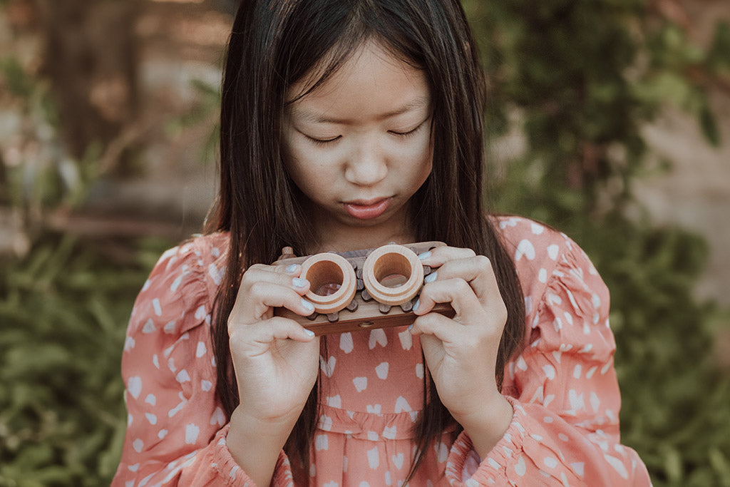 Twinkle wooden toy camera inspired by the stereo camera offers double the fun with two kaleidoscope lenses. Like a wooden binocular toy, Father’s Factory twinkle wooden toy camera has 2 lenses. Children can look through the lenses and find wonders. The kaleidoscopic lens will enhance creativity in children and offers high-quality playtime. Father's factory wooden toys can double as interior decor, kid’s room decor, and playroom display.