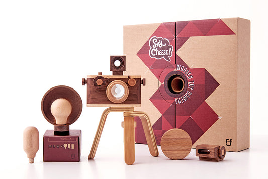 EXPERT Wooden Toy Camera Gift Set featuring a 35mm wooden camera, wooden tripod, and four wooden flashes; designed for creative play and home decor. Includes a kaleidoscopic lens and clickable shutter button, perfect for imaginative adventures with your little photographer. Durable construction ensures lasting fun and family enjoyment