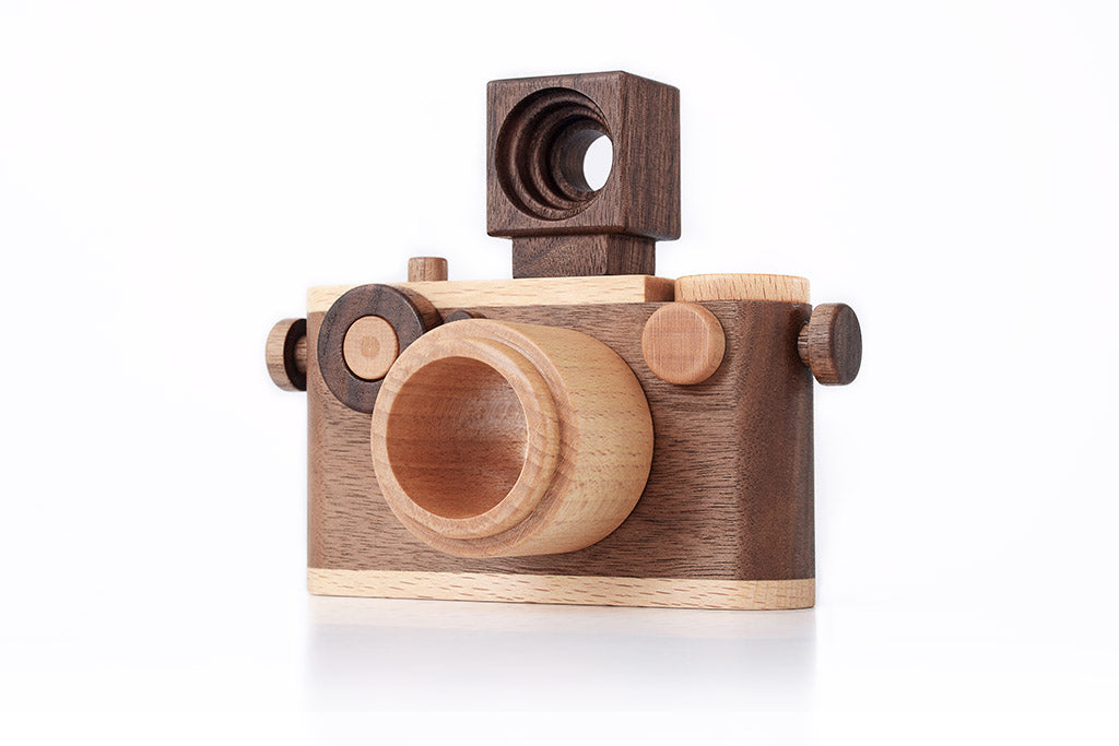 Handcrafted wooden toy camera made of walnut wood, featuring a detachable flash and kaleidoscope lens with timeless design.