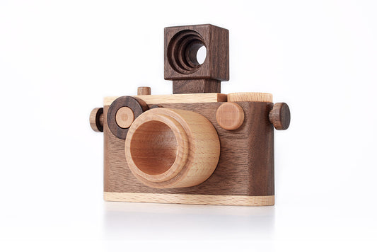 Handcrafted wooden toy camera made of walnut wood, featuring a detachable flash and kaleidoscope lens with timeless design.