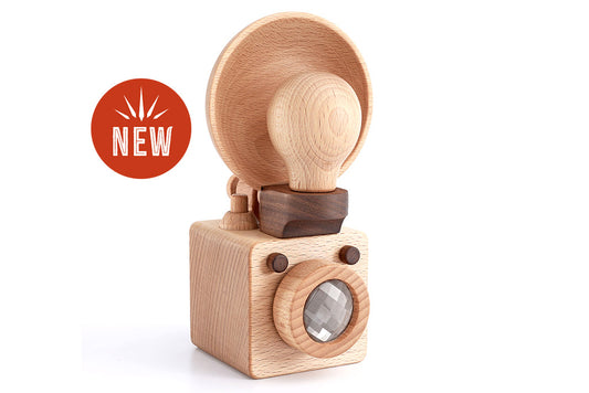 A wooden toy camera inspired by the vintage Kodak Brownie camera, crafted from high-quality walnut and beechwood. This modern take on the classic design is non-toxic, biodegradable, and perfect for children’s open-ended playtime, while also doubling as decor.