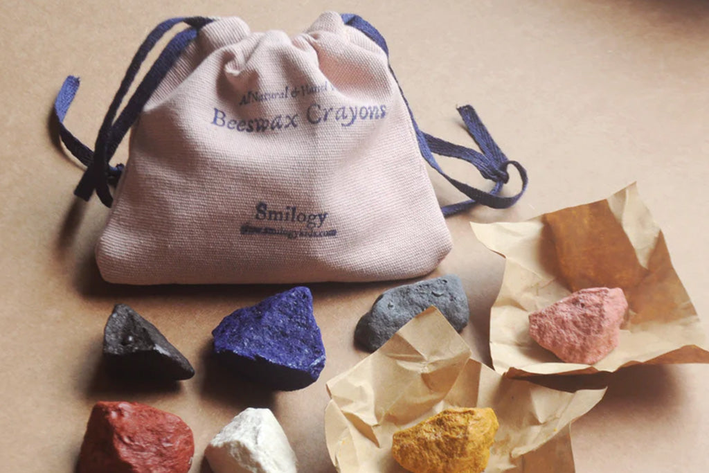 Natural beeswax non-toxic crayons shaped like ocean rocks in 8 colors, packed in a cotton drawstring sack