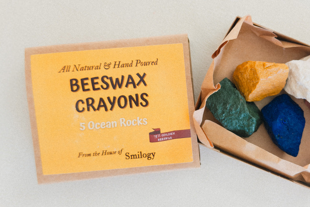 Box of hand-poured beeswax crayons shaped like ocean rocks in five colors, non toxic and eco-friendly perfect for young artists