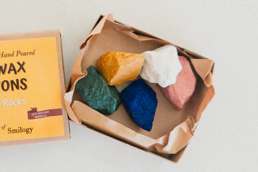 Box of hand-poured beeswax crayons shaped like ocean rocks in five colors, non toxic and eco-friendly perfect for young artists