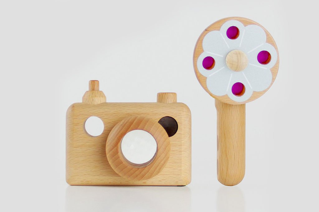 Photo shows a wooden toy camera inspired by the vintage 35MM camera on display. The toy camera comes with a vintage flash, and it’s the best first camera for encouraging children’s creativity. Wooden toys are safer than plastic toys because they are made of non-toxic and biodegradable materials. When choosing wooden toys, wooden toy camera is the essential type of toy for your child’s open-ended playtime. Choose from Father’s Factory wooden toy camera today as they are the toys double as interior decor.