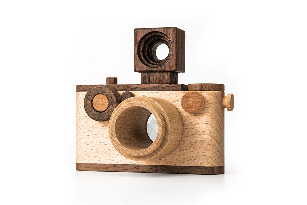 Beautifully crafted wooden toy camera made of beech and walnut wood, featuring a kaleidoscope lens and detachable flash.