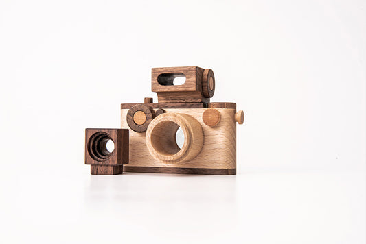 Father's Factory wooden toy camera, 35MM Original wooden toy camera with detachable magnetic flash, clickable button, and kaleidoscopic lens. It’s the perfect toy camera for pretend play, sensory play, and homeschooling. This camera for kids is made of walnut and beechwood with heirloom quality. Non-toxic wooden toys, child-led play wood toys, wooden toys for children, and environmental friendly toy. Tested To Meet All Safety Standards. The wooden toy camera can be an interior decor item for a kid’s room.