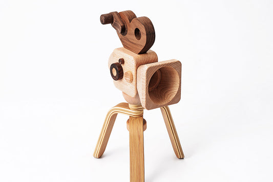 Father's Factory new super 16 Wooden Toy Camera is perfect for you! Stories play a vital role in the growth and development of children, and this Super 16 elevates the whole pretend-play experiences. The Super 16 Pro has a spinning rewind level, swivel lens, kaleidoscopic viewfinder, spinning shutter, and a tripod that can be for play and children’s room decor