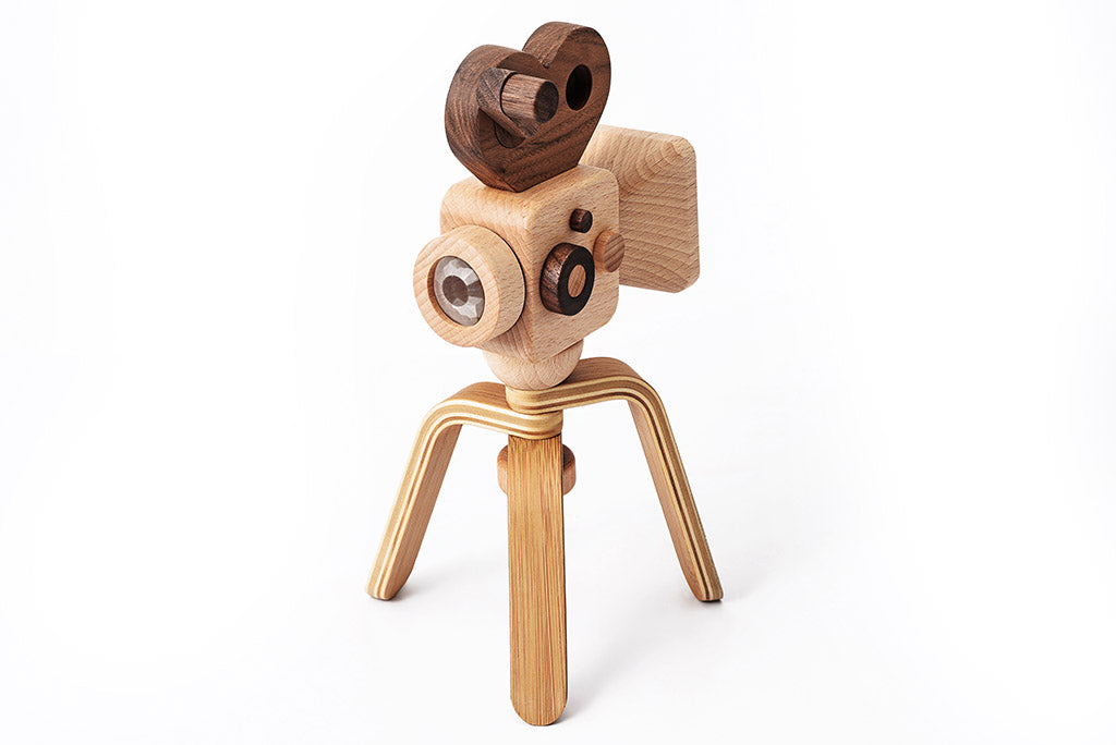 Father's Factory new super 16 Wooden Toy Camera is perfect for you! Stories play a vital role in the growth and development of children, and this Super 16 elevates the whole pretend-play experiences. The Super 16 Pro has a spinning rewind level, swivel lens, kaleidoscopic viewfinder, spinning shutter, and a tripod that can be for play and children’s room decor