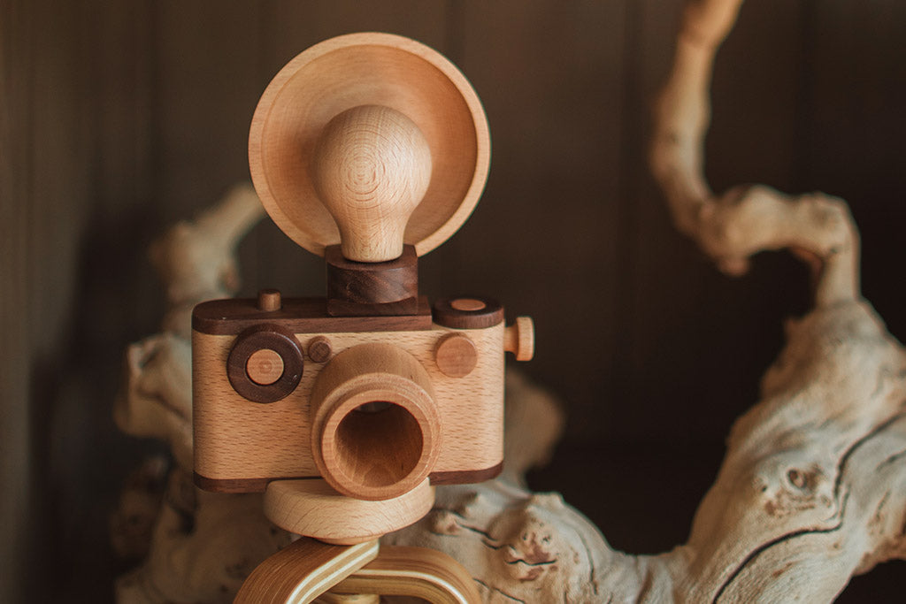 Photo shows a vintage inspired camera flash magnetic attached to the 35MM wooden toy camera. The toy camera flash is made with high quality walnut and breech wood. It is the perfect accessory for the 35MM wooden toy camera collection. Wooden toys are safer than plastic toys because they are made of non-toxic and biodegradable materials. When choosing wooden toys, wooden toy camera is the essential type of toy for your child’s open-ended playtime. Choose from Father’s Factory wooden toy camera today.