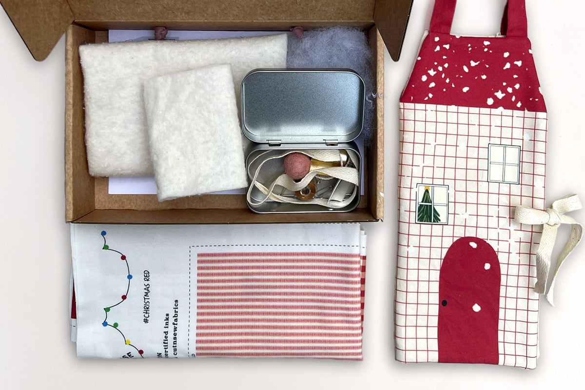 Get ready for the holiday season with this festive Cut &amp; Sew Dollhouse Advent Calendar! Perfect for sewing enthusiasts of all skill levels, this dollhouse advent calendar offers a fun way to make a seasonal gift or a cherished keepsake for your little one. Combining a unique holiday design with sustainable materials, this craft project brings handmade warmth to your holiday preparations. The holiday dollhouse also doubles as on-the-go play activity. Everything you need to make this dollhouse is included