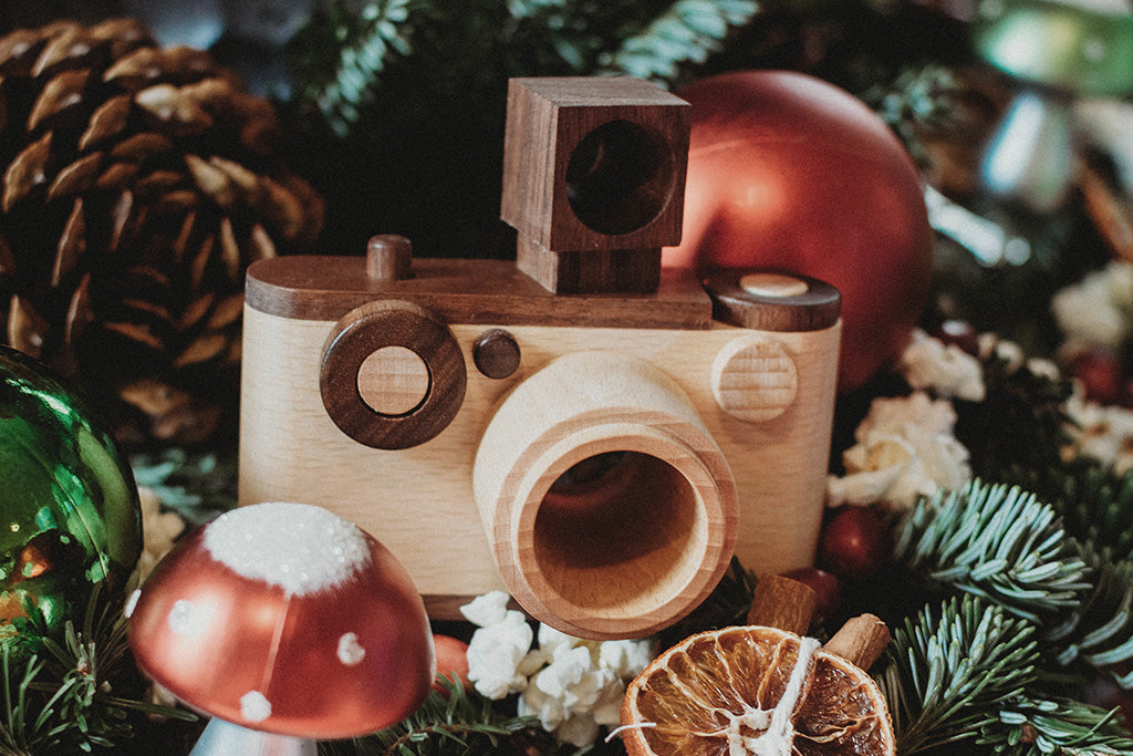 Wooden toy camera with detachable lens, crafted from walnut and beechwood, makes it a perfect holiday decor.