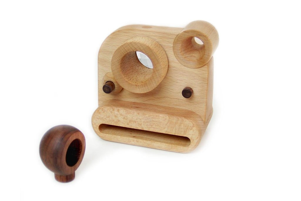 Father's Factory wooden toy camera, Polaroid style wooden toy camera has kaleidoscopic lens. It’s perfect of pretend play, open ended play, sensory play, and homeschooling. Montessori and Waldorf toy. It’s made of walnut and beechwood with heirloom quality. No Battery-Operated or Plastic Toys. Perfect interior decor for kid’s room. It comes with detachable wooden flash, swivel lens, clickable shutter, and kaleidoscope viewfinder.