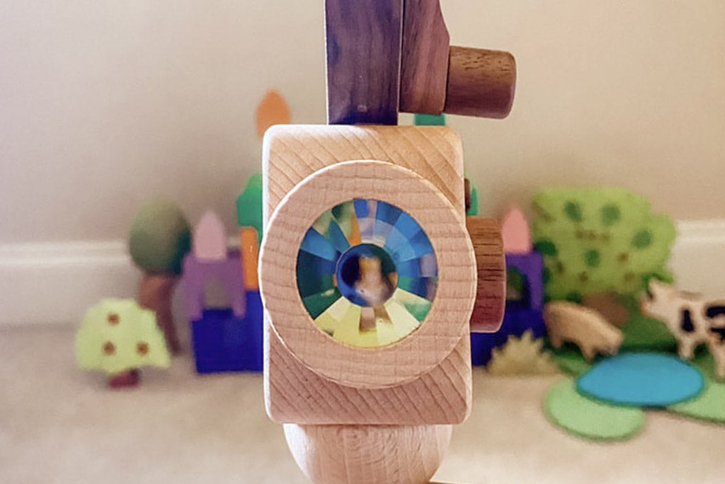 Father's Factory new super 16 Wooden Toy Camera is perfect for you! Stories play a vital role in the growth and development of children, and this Super 16 elevates the whole pretend-play experiences. The Super 16 Pro has a spinning rewind level, swivel lens, kaleidoscopic viewfinder, spinning shutter, and a tripod that can be for play and children’s room decor